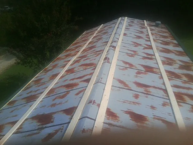 Rusted metal roof panels with new wood purlins before replacement — Storm Damage Roof Repair in Maytown by Roofing Brothers