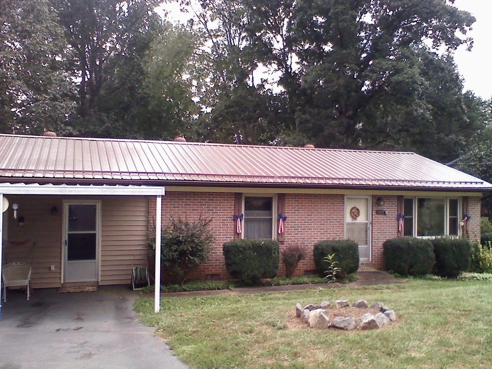 Bronze metal roof and carport on a brick ranch home — Roof Repair work by our crew in Maytown